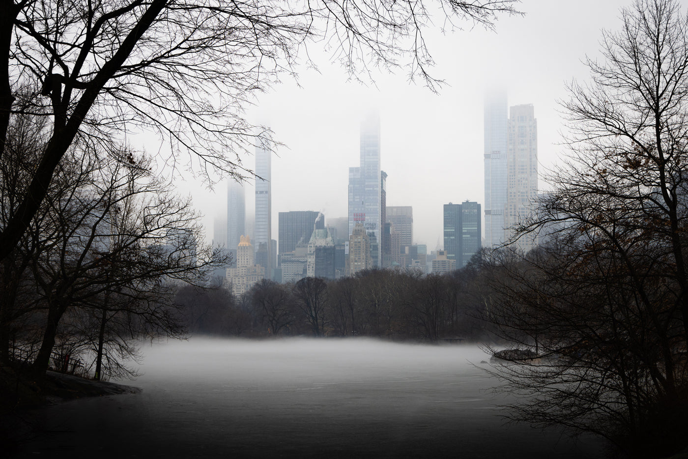 Foggy lake in Central Park with sky scrapers in the background