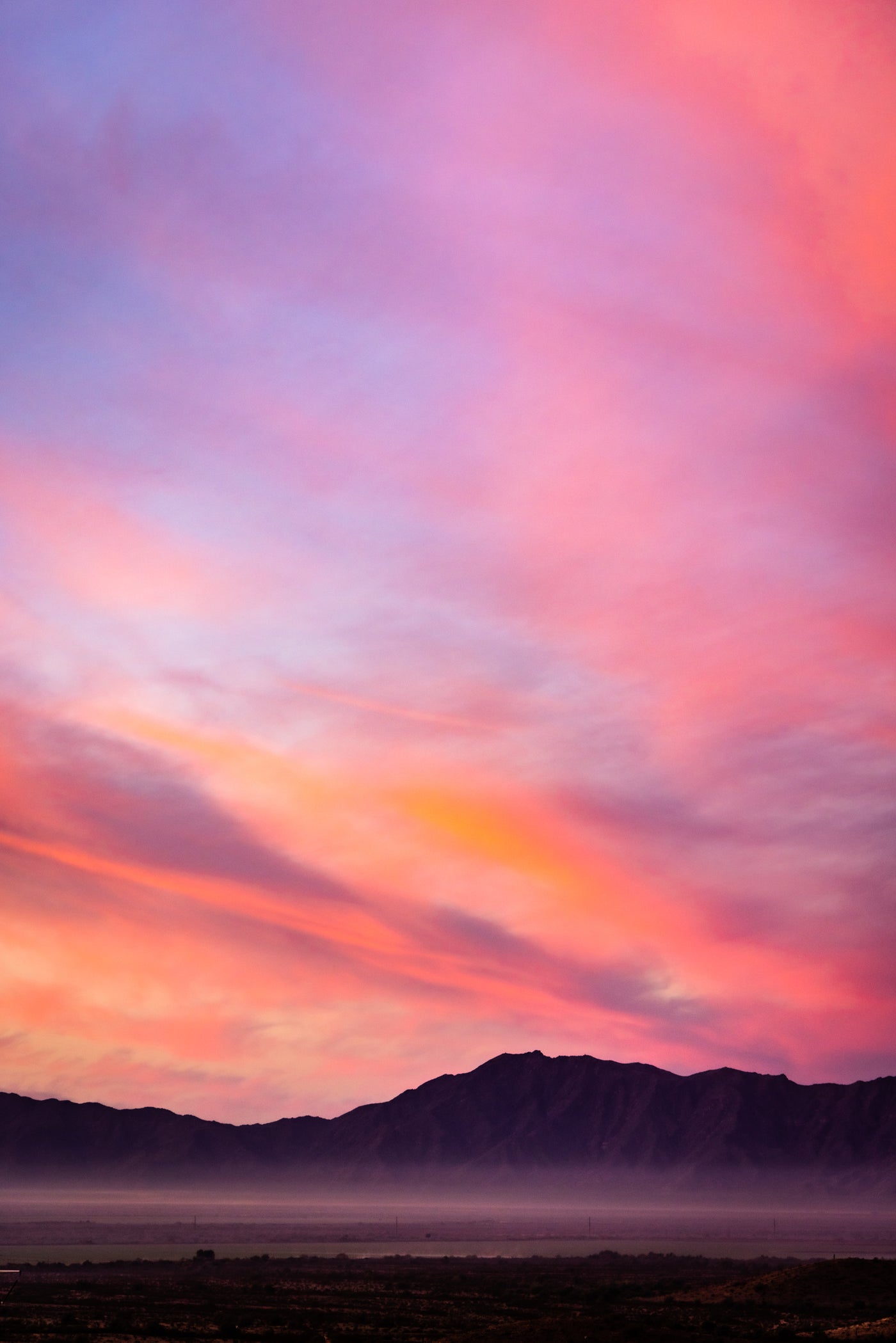 Pink and purple colored sunset over the desert mountains