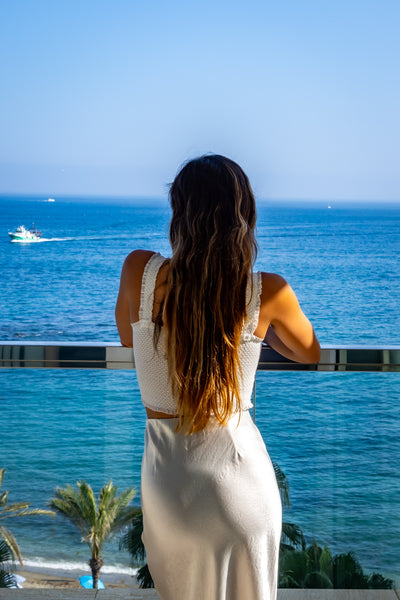 Girl looking at ocean from balcony