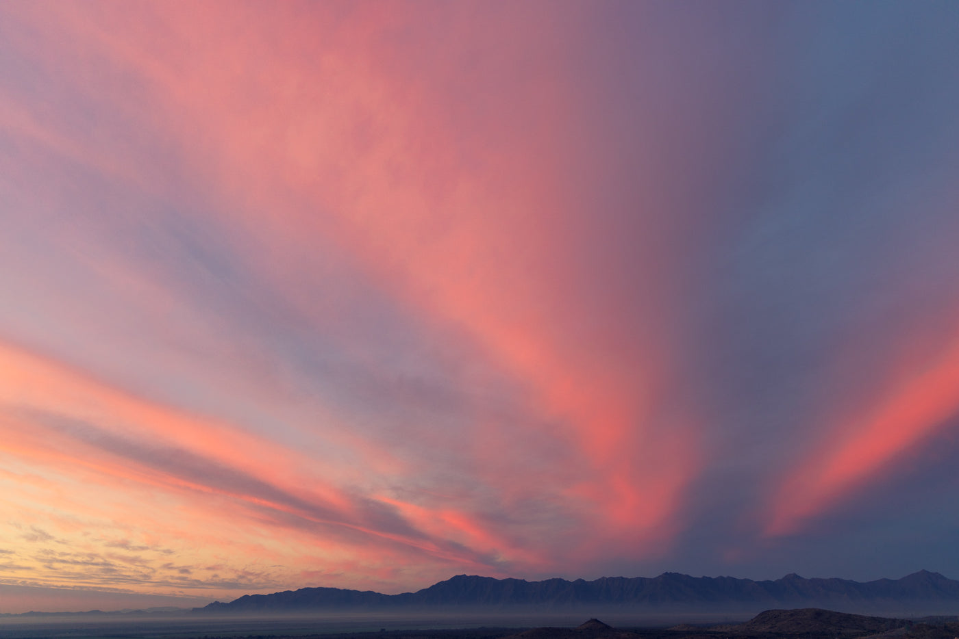 Pink and blue sunset over mountain range