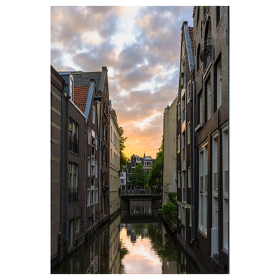 Cloudy sky over canal and buildings in Amsterdam