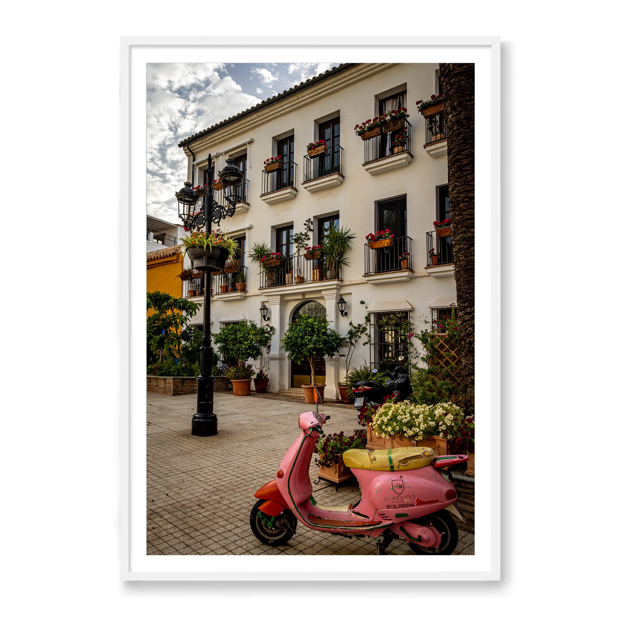 White framed photo of pink moped 