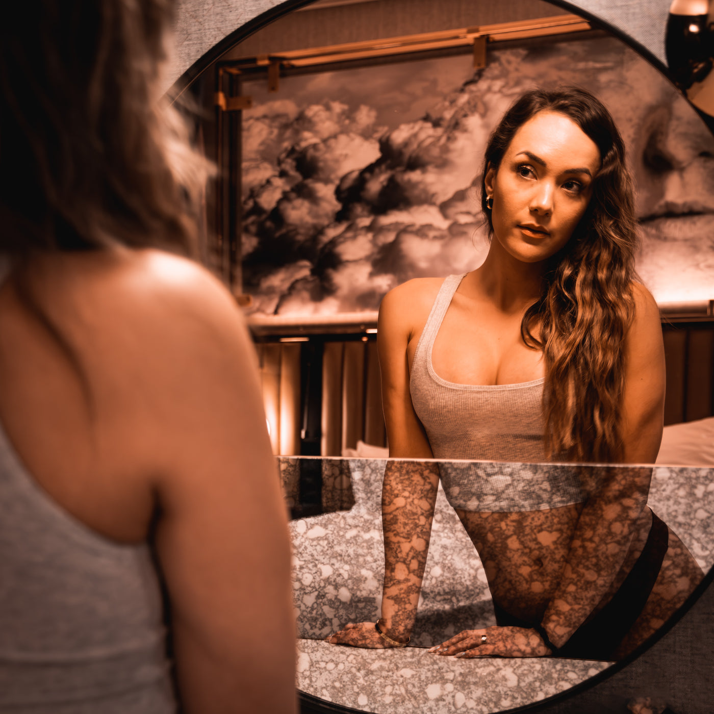 Woman looking at her reflection in mirror