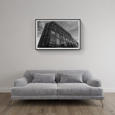 Framed photo of Modern architecture building above couch
