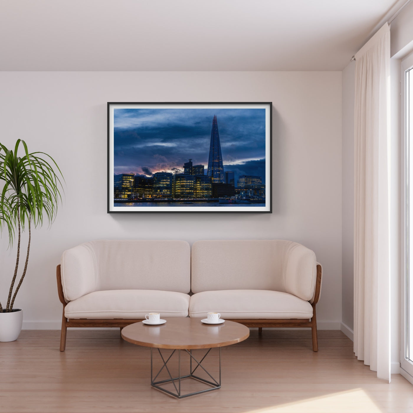 The Shard building in London, England with blue and purple sunset photo above white couch