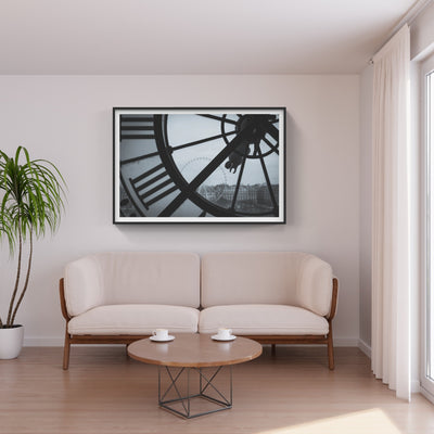 Close up view of a clock with a ferris wheel in the distance photo above white couch
